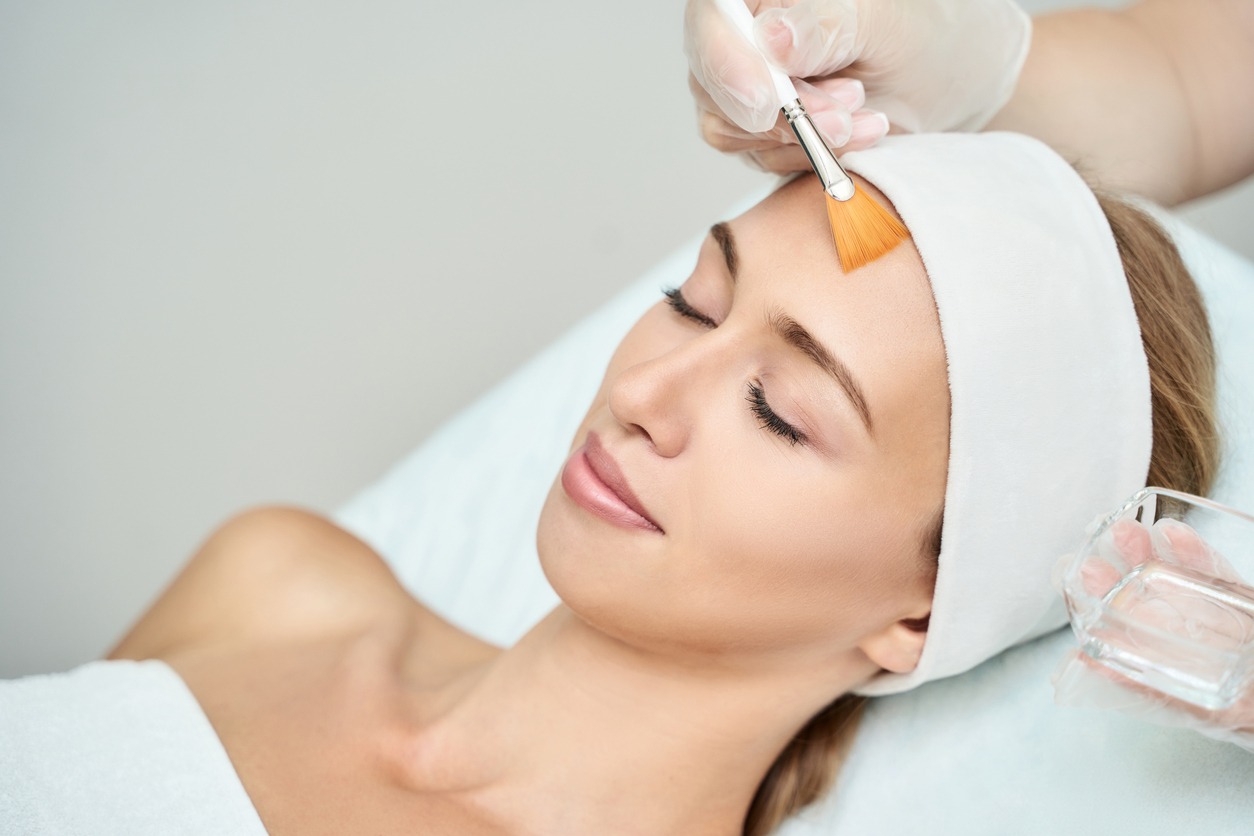 Young woman skin care. Rejuvenation treatment. Facial chemical peel therapy. Clinical healthcare.